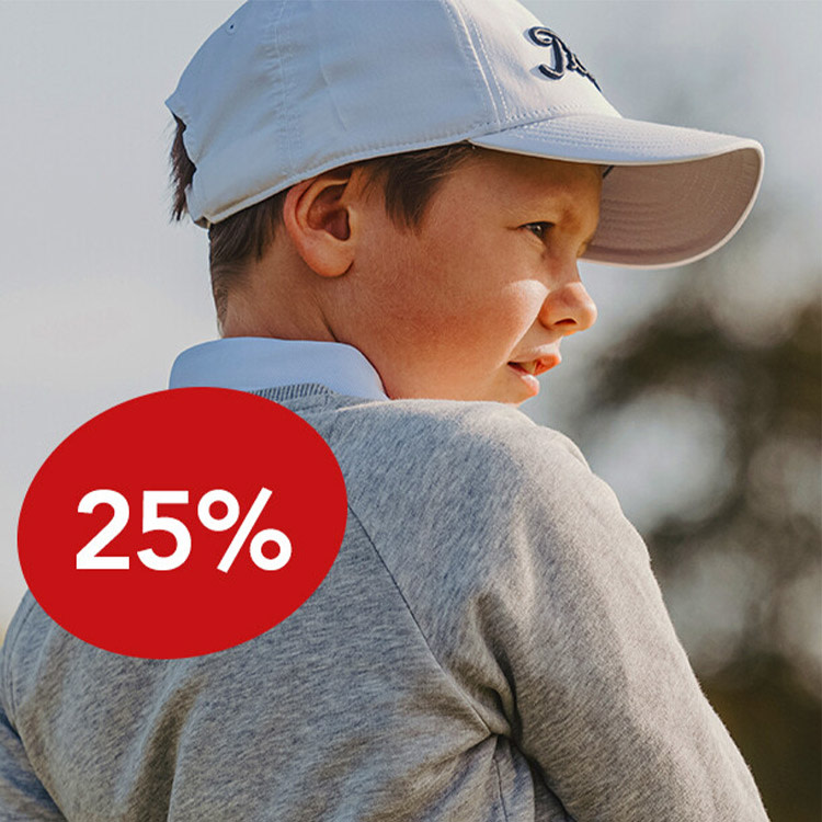 Pojke i grå tröja och vit keps tittar åt sidan utomhus, röd cirkel med texten "25%" syns i förgrunden.